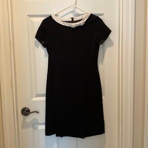 Black dress with white trimmed collar and small bow..pretty and tasteful!